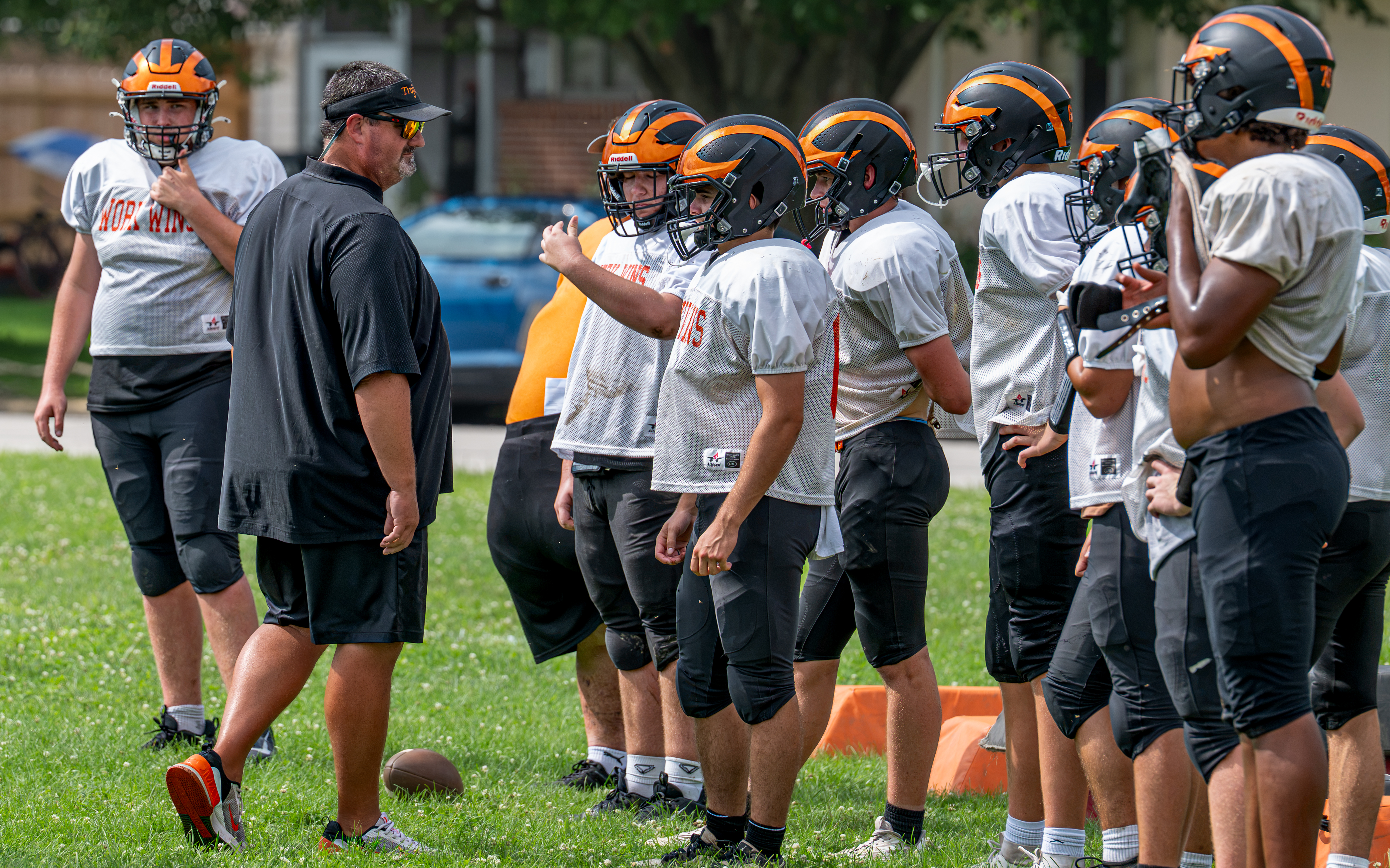 Coach Macy instructs the Trojans in preparation of their season opener